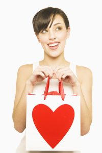26 Jan 2006 --- Woman Holding Valentine's Day Gift Bag --- Image by © Royalty-Free/Corbis