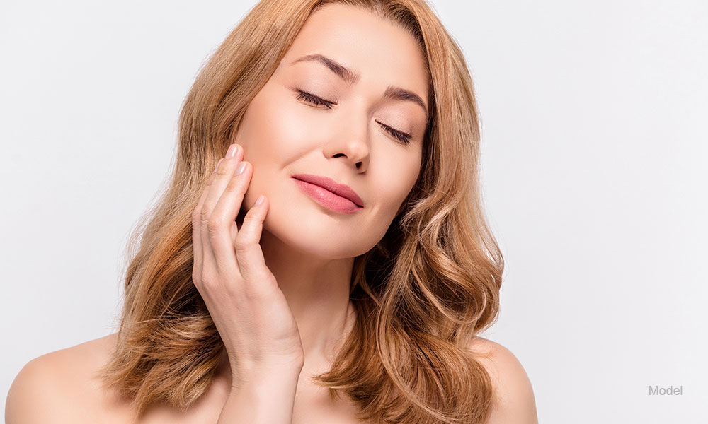 mature woman with her hand in her face